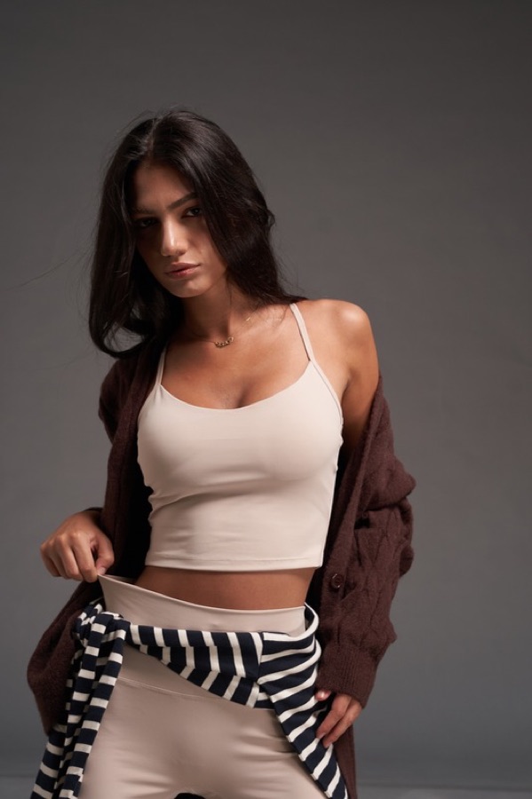 Cream bra top with striped sweater tied at the waist