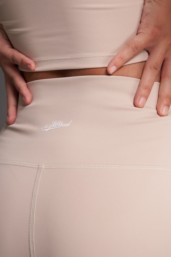 Close-up of beige leggings and bra top